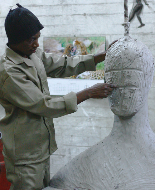 artist sculpting an abstract human bust