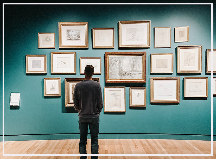 person viewing work on display on a wall at the gallery