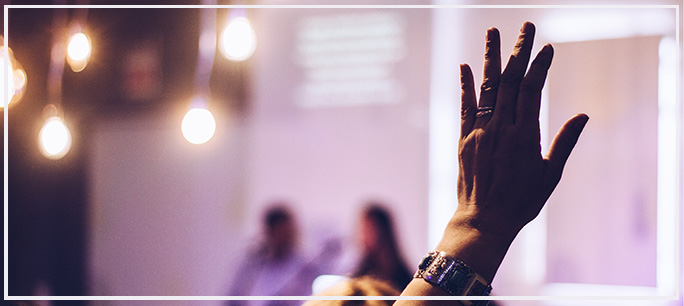 artist lecture with participant raising hand to ask a question