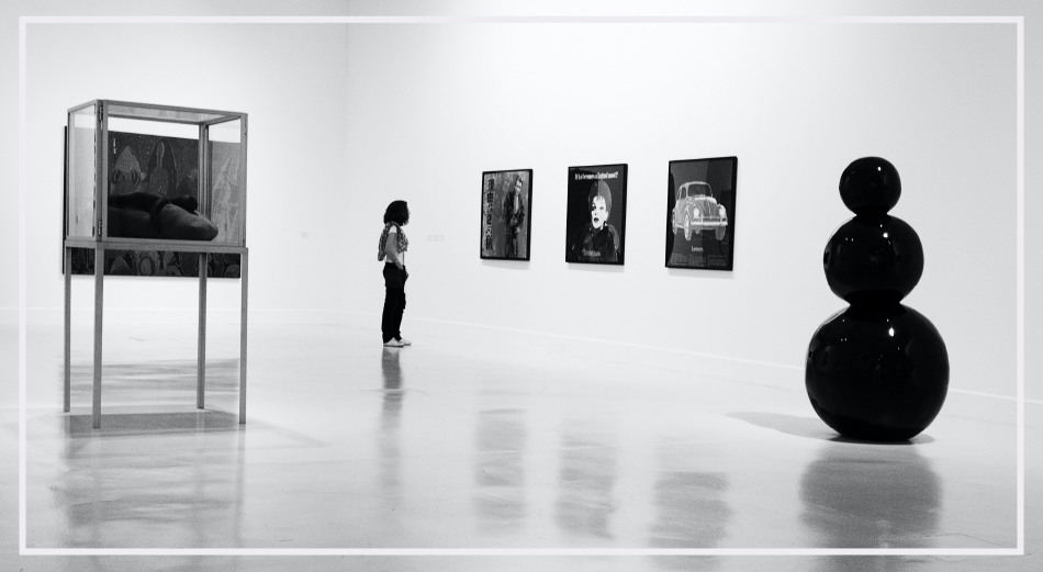 person walking through sculptural art gallery space